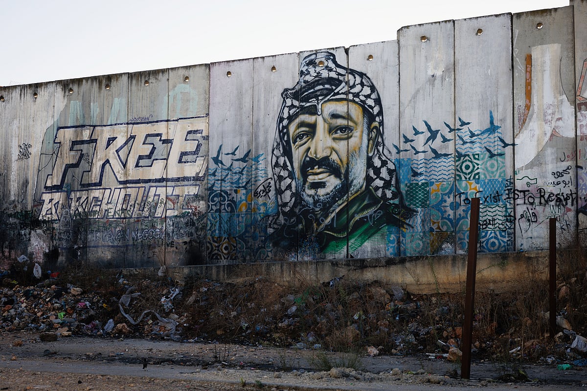 A mural on Israel's controversial wall between Jerusalem and Ramallah showing former PLO chairman Yasser Arafat (photo: Getty Images)
