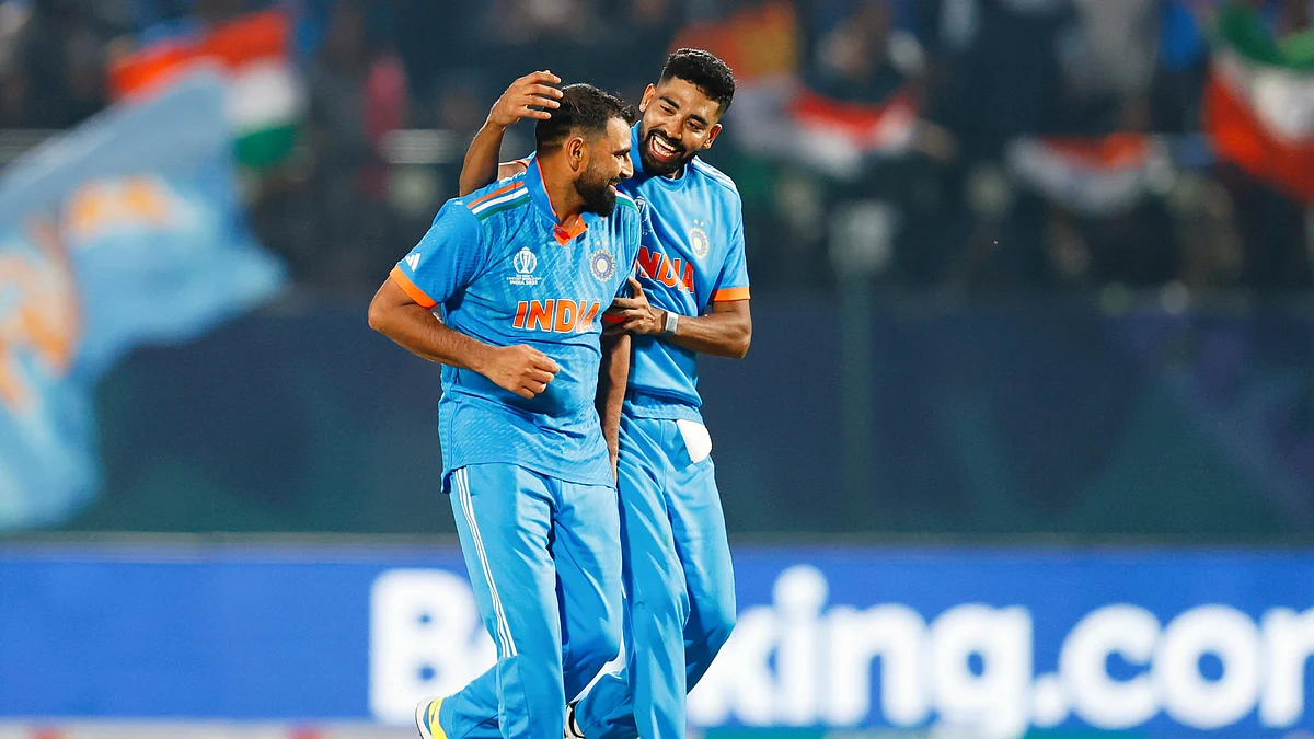 Mohammed Shami (left) celebrates with Mohammed Siraj in a World Cup match against New Zealand in Dharamsala (photo: Getty Images)