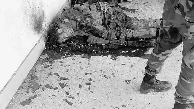A Pak army soldier stands guard near the bodies of militants killed at Mianwali on Saturday