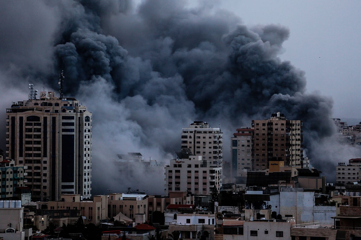 Smoke rises over buildings in Gaza City on 9 October during an Israeli air strike (photo: Getty Images)