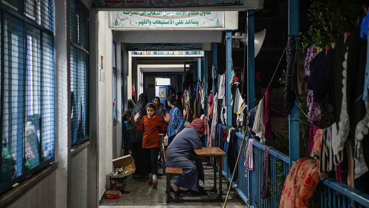 Women and children at an UNRWA school sheltering displaced Palestinians in Khan Yunis, Gaza on 22 October (photo: Getty Images)
