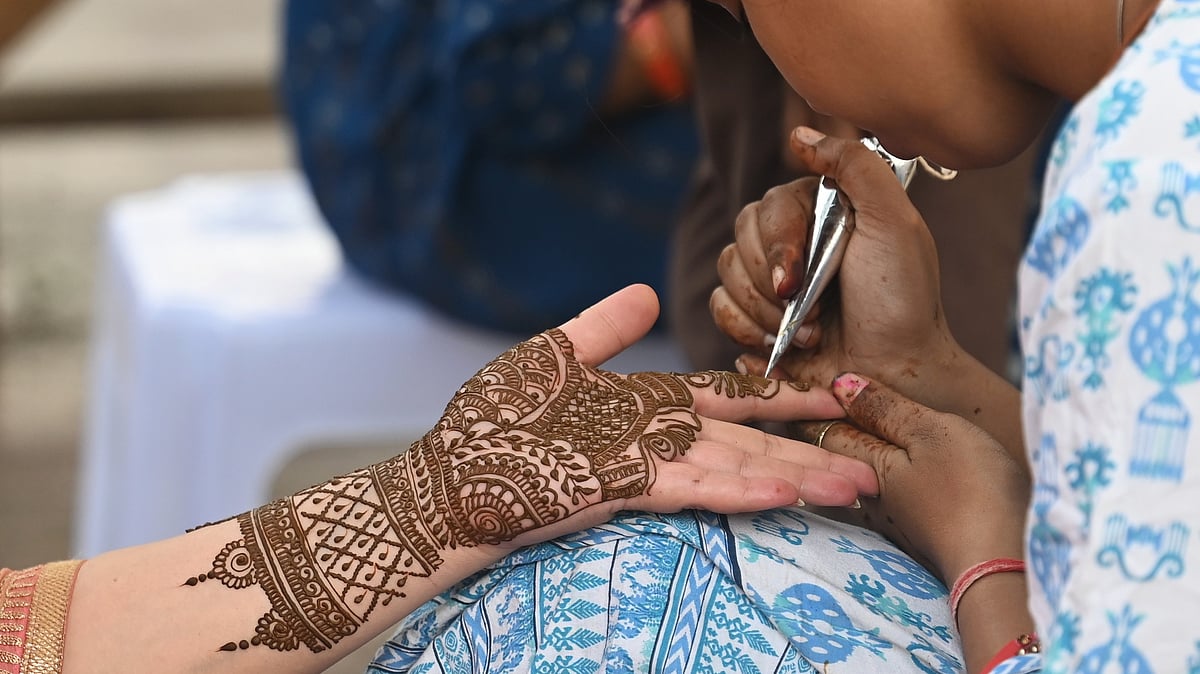 Citing 'love jihad' concerns, Vishwa Hindu Parishad organises mehendi camps to 'protect Hindu girls' from Muslim artists. Henna decoration (representative image) is popular during Karwa Chauth (photo: Vipin Kumar/Hindustan Times via Getty Images)