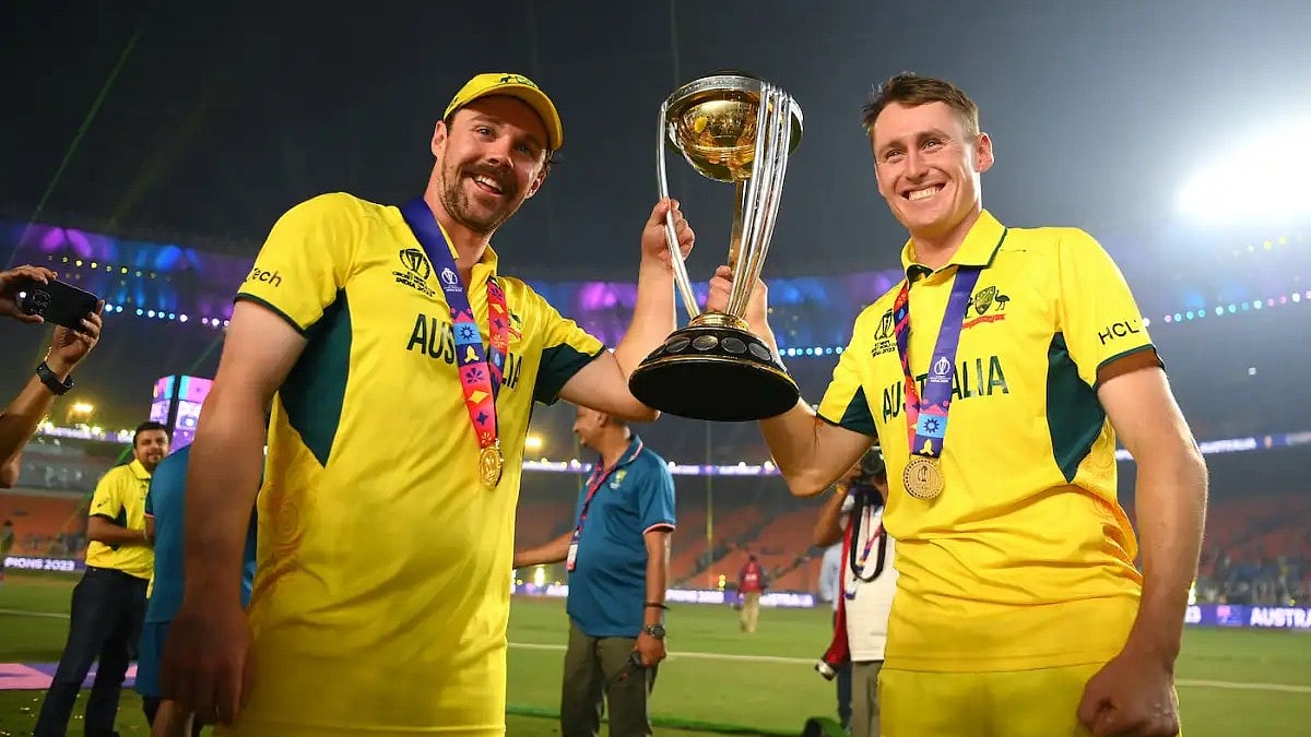 Travis Head & Marnus Labuschagne with the trophy after Australia beat India by 6 wickets on 19 November at the ICC World Cup final, in Narendra Modi Stadium, Ahmedabad (photo: ICC/Getty Images)