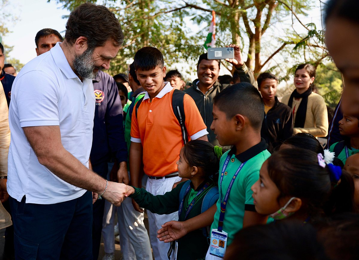 Rahul Gandhi speaks to schoolchildren gathered along the route to greet the Nyay Yatra bus