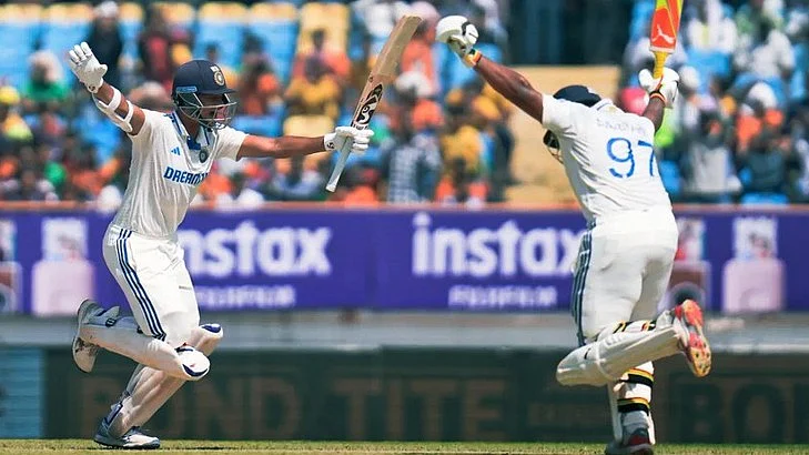 Yashavi Jaiswal (left) celebrates his double century with Sarfaraz Khan (photo: @BraveOfTheBihar/X)