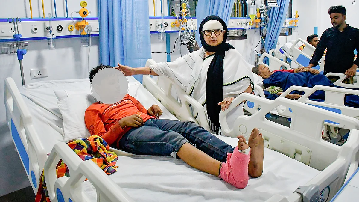 West Bengal chief minister Mamata Banerjee with a child injured in the collapse (photo: PTI)