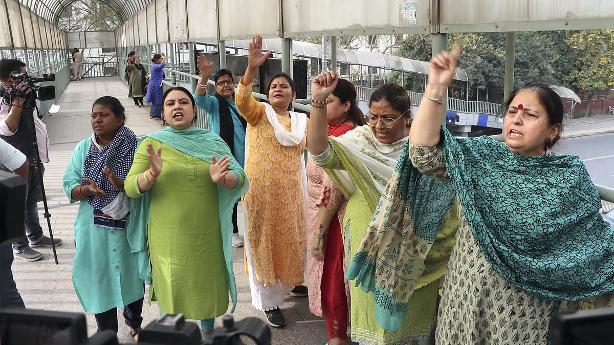 AAP workers and supporters raise slogans during a protest in New Delhi on 24 March 24