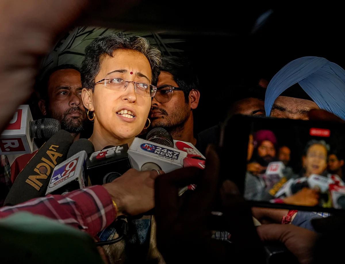 Atishi speaks to media outside Kejriwal's residence (photo: PTI)