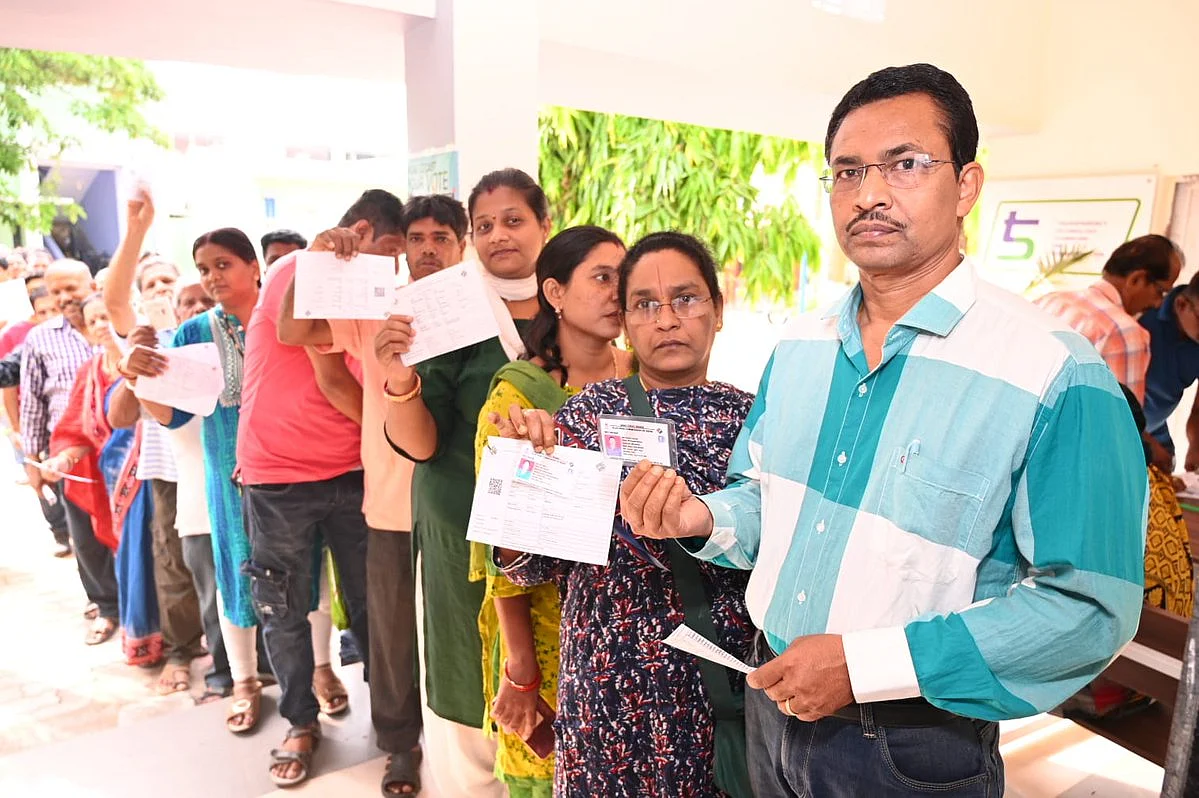 Voters queued up with their voting slips at a polling booth in Odisha (photo courtesy @OdishaCeo/X)