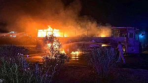 The bus catches fire in Haryana's Nuh district on 18 May (photo: PTI)