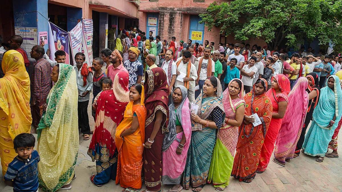 Voters wait to cast their vote for the third phase of Lok Sabha elections, in Khagaria, 7 May (photo: PTI)