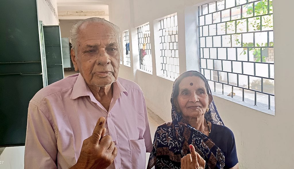 An elderly couple come out of the polling booth in Bilaspur (photo courtesy @BilaspurDist/X)