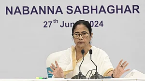 Mamata Banerjee addresses a review meeting in Howrah on 27 June (photo: PTI)