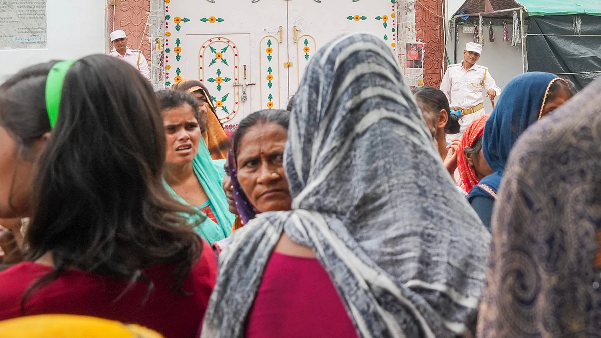 People gather near the ashram in Kasganj on 4 July (photo: PTI)