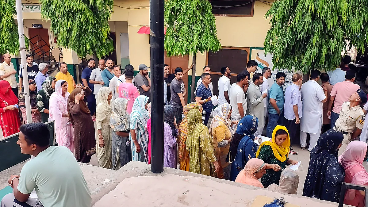 Voters wait in queues at a polling station during the Nalagarh assembly bypoll (photo: PTI)