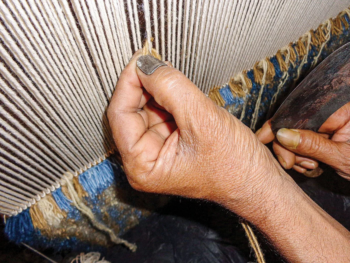 Weavers use woollen thread for line stitches