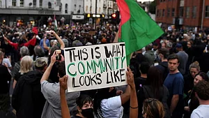 'This is what community looks like' placard at an anti-racism protest in Bristol