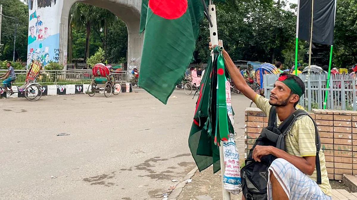 A flag seller on a Dhaka street, 19 Aug (photo: PTI)