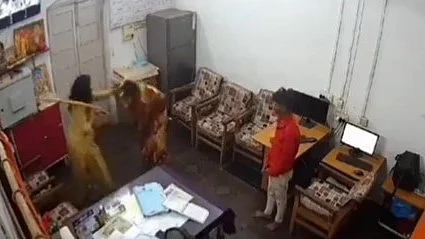 Screengrab of the video showing a woman officer assaulting two persons (source: @jigneshmevani80/X)