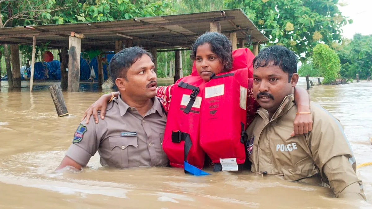Telangana: Rescue officials save a girl in a flood-affected area