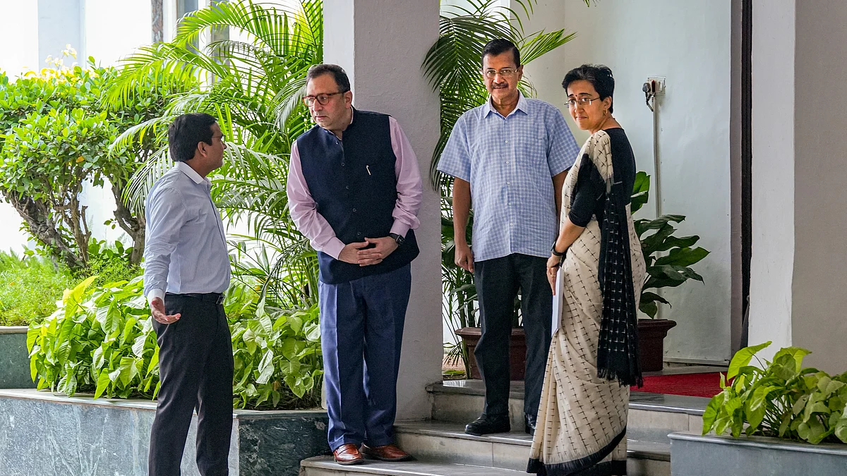 AAP convenor Arvind Kejriwal (top of steps) at Delhi governor's residence and CM designate Atishi (right)