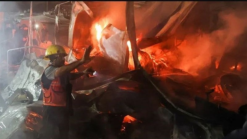 First responders battle a blaze from the IDF air strike on a refugee camp next to Al-Aqsa Hospital, Gaza