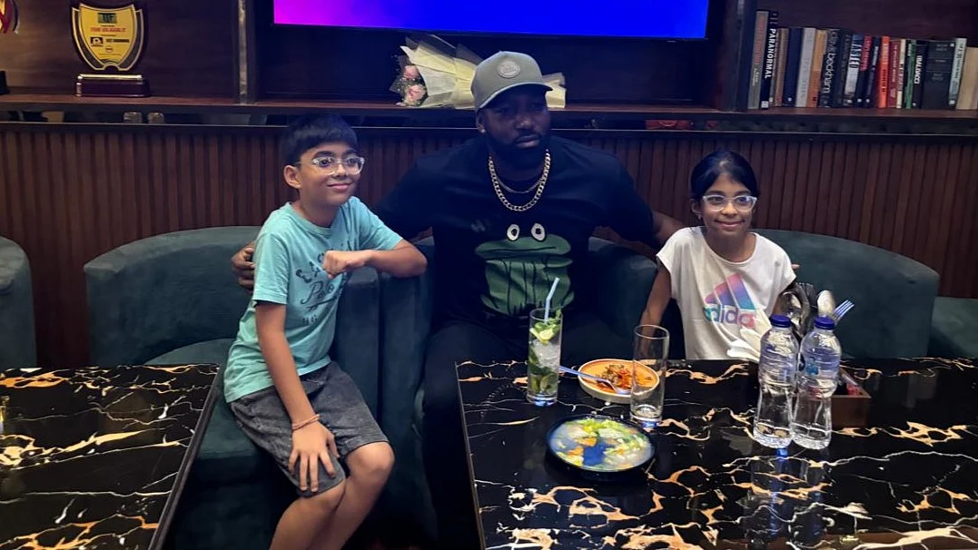 Kesrick Williams with two young fans in Kolkata (photo courtesy: The Dugout)