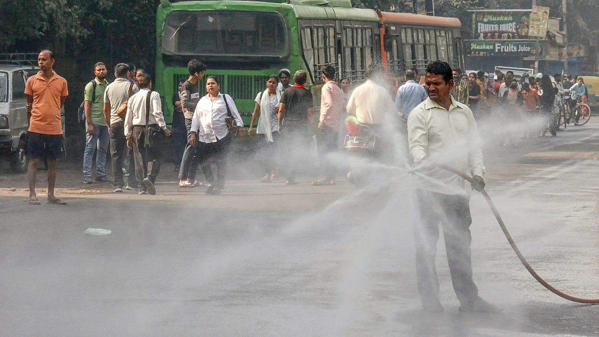 Water being sprinkled to curb air pollution at Jahangirpuri, New Delhi