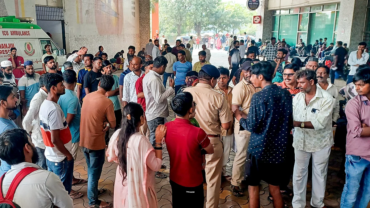Relatives of injured passengers wait outside a hospital in Mumbai on 27 October (photo: PTI)