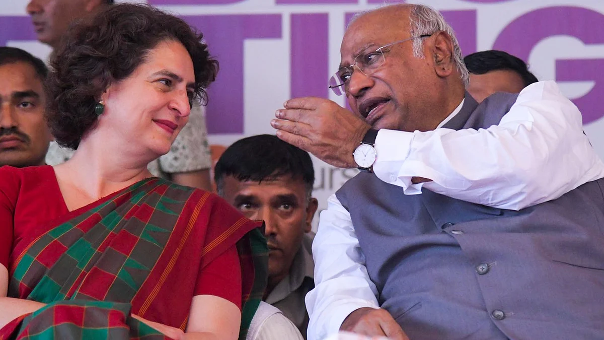 Congress president Mallikarjun Kharge (right) speaks with Priyanka Gandhi Vadra (left)