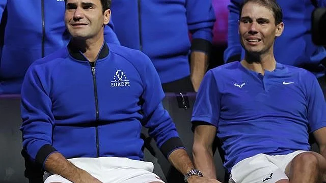 Roger Federer (left) and Rafael Nadal: Great rivals, greater friends hold hands
