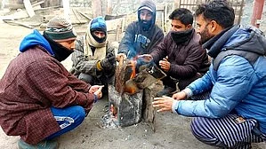 Residents protect themselves from cold in Srinagar (photo: IANS)