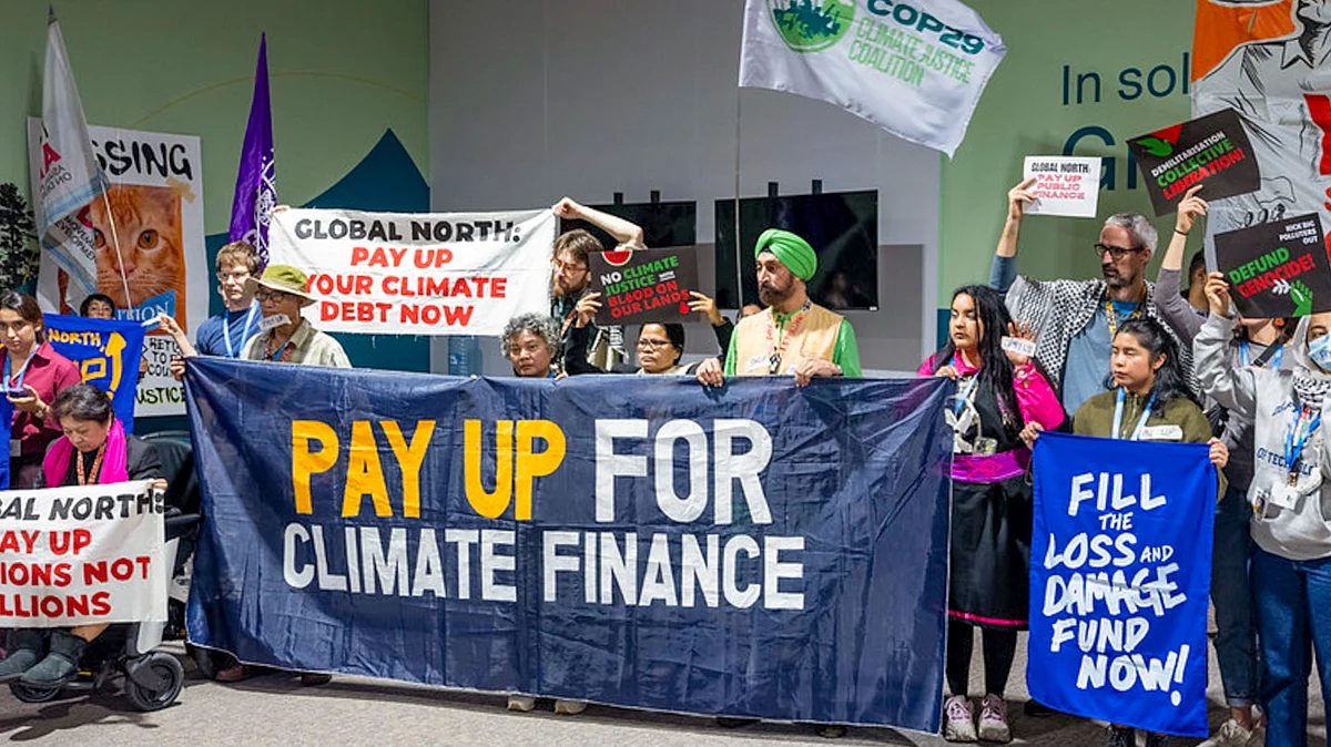 Civil society members stage a silent march at COP29, Baku, 23 Nov. 2024 (Photo: PTI)