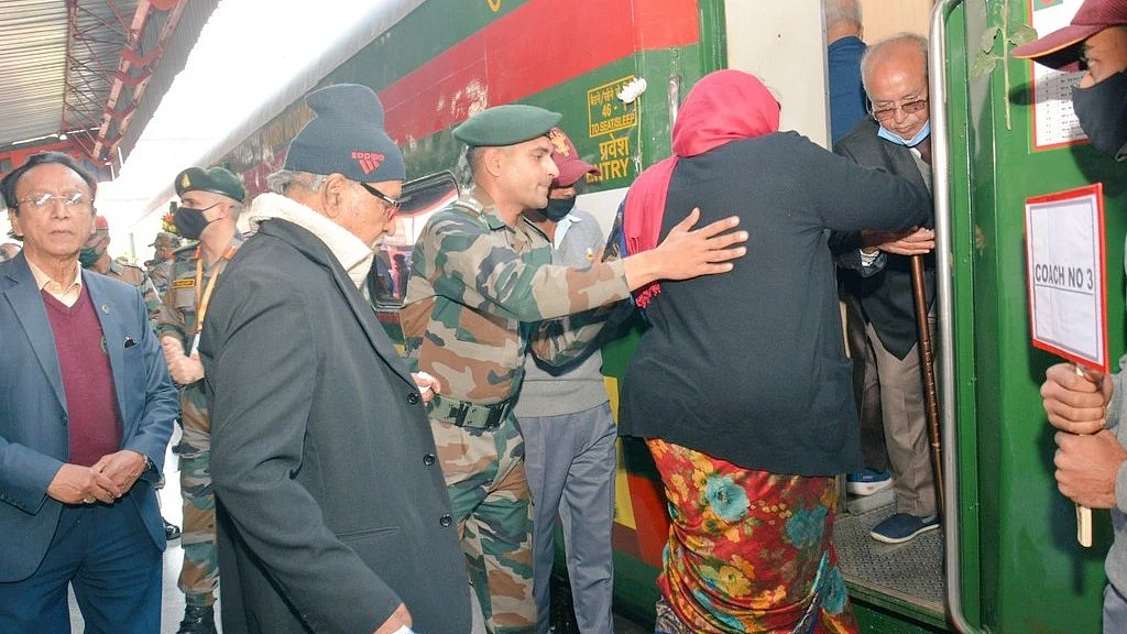 Indian army personnel help passengers on the Swarnim Vijay Varsh Special train to Bangladesh