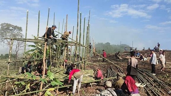 Locals help construct shelters for Bangladeshi refugees in a village in Lawngtlai district