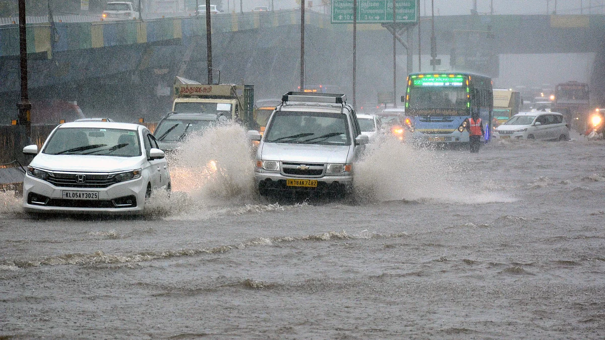 Vehicles wade through a waterlogged road amid rains caused by cyclone Fengal