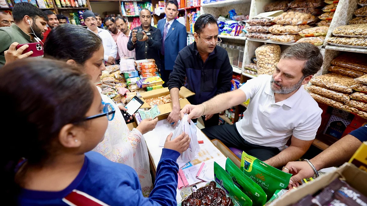 Rahul Gandhi (right) tries out for a job at a kirana shop in Bhogal, Delhi