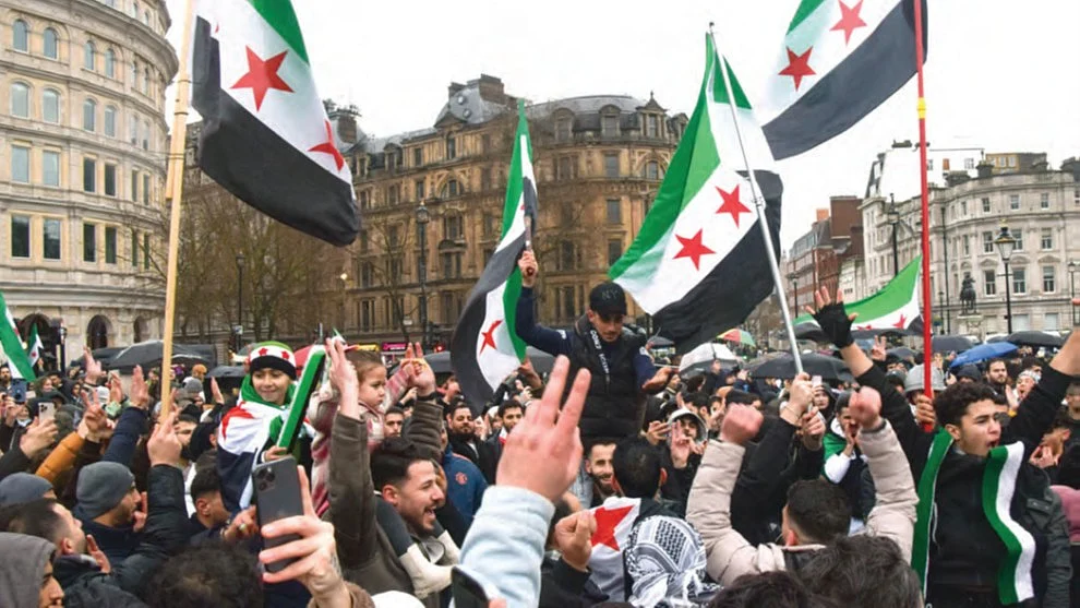 Syrians in London celebrate the ouster of Bashar al-Assad, 8 Dec. 2024 (Getty)