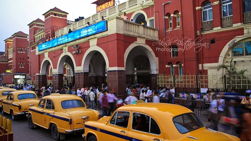 Kolkata's iconic yellow Ambassador taxis lined up outside Howrah railway station
