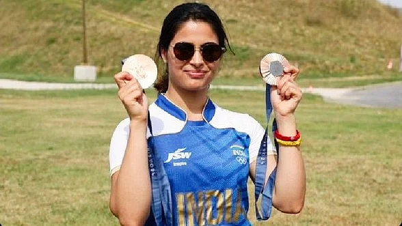 Manu Bhaker with her double bronze medals outside the Olympics shooting range