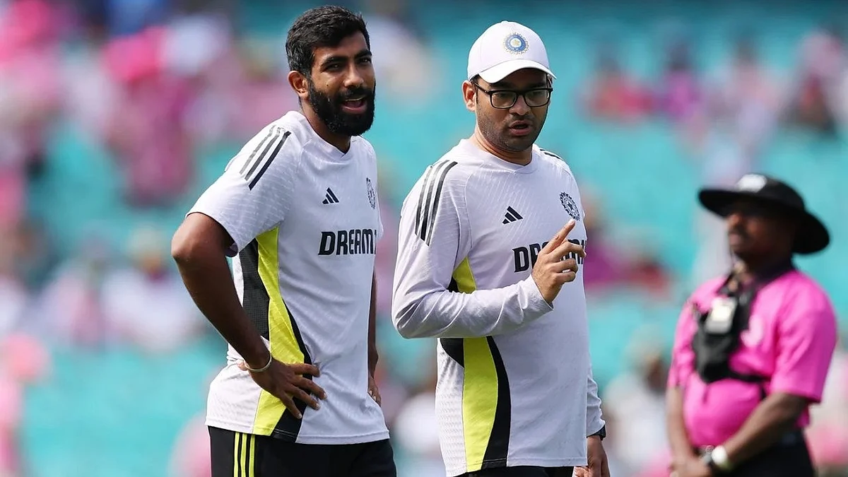 Spirit is willing... Jasprit Bumrah (left) with India's team physiotherapist Nitin Patel in Sydney