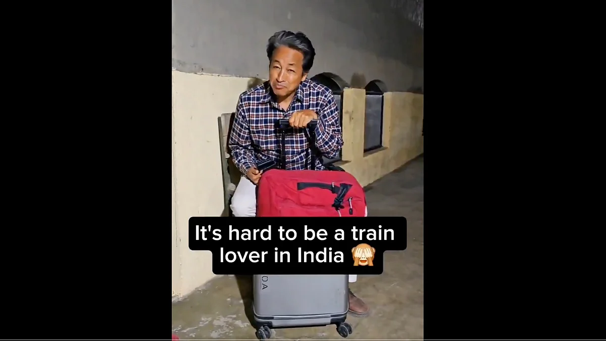 Sonam Wangchuk waits at the railway station for a train running well behind schedule