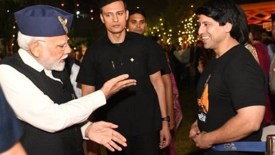 Shehzad Poonawalla (right) exchanges a laugh with PM Narendra Modi (left)