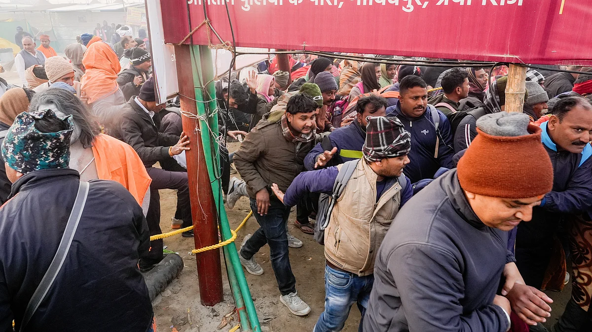 Devotees break through a barricade on Mauni Amavasya at Maha Kumbh (photo: PTI)