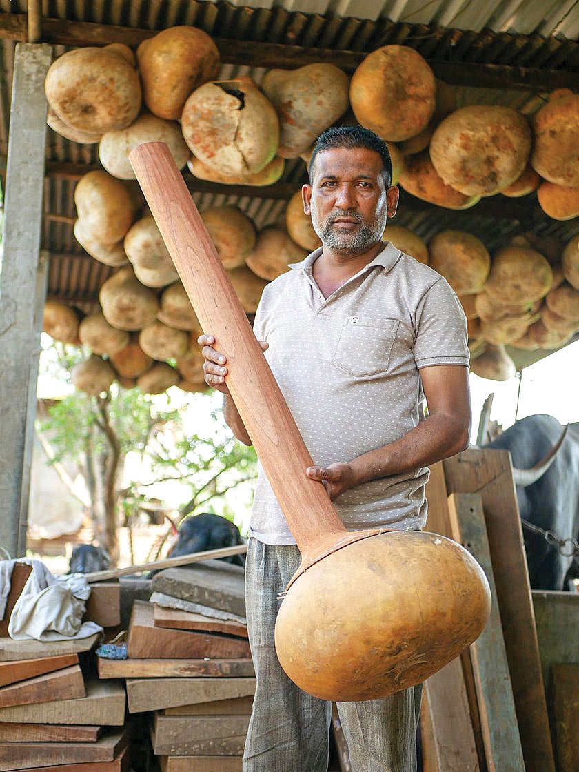 Imtiyaz poses with the skeleton of the instrument he has made