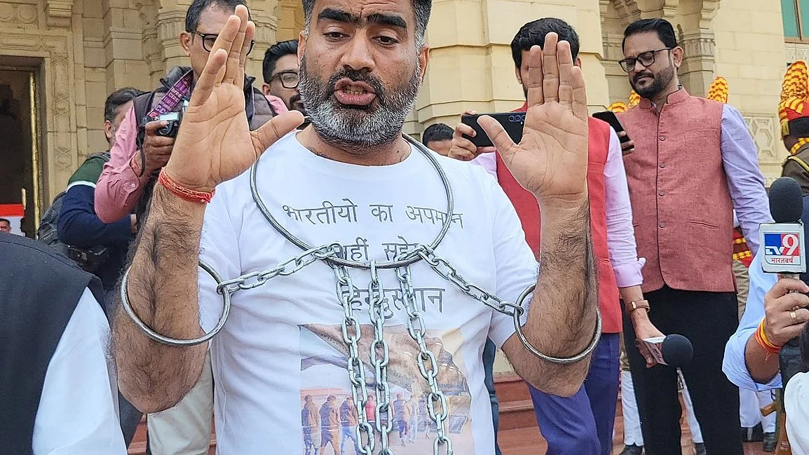 Samajwadi Party MLA Atul Pradhan dons shackles to make his point about the humiliation of US deportees