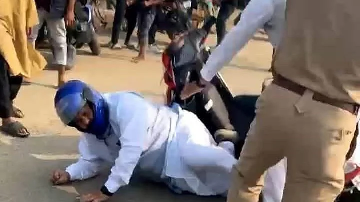 Congress MP Rakibul Hussain falls to the ground under attack by several wielding cricket bats