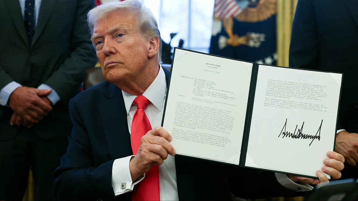 Donald Trump holds a memorandum at White House on 25 February (photo: PTI)