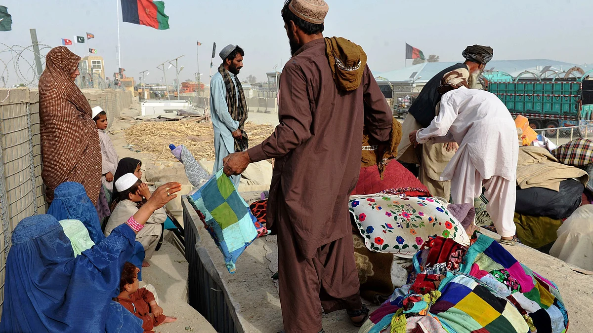 Afghans returning from Pakistan wait for the truck to take them home at the Spin Buldak border, 2016.