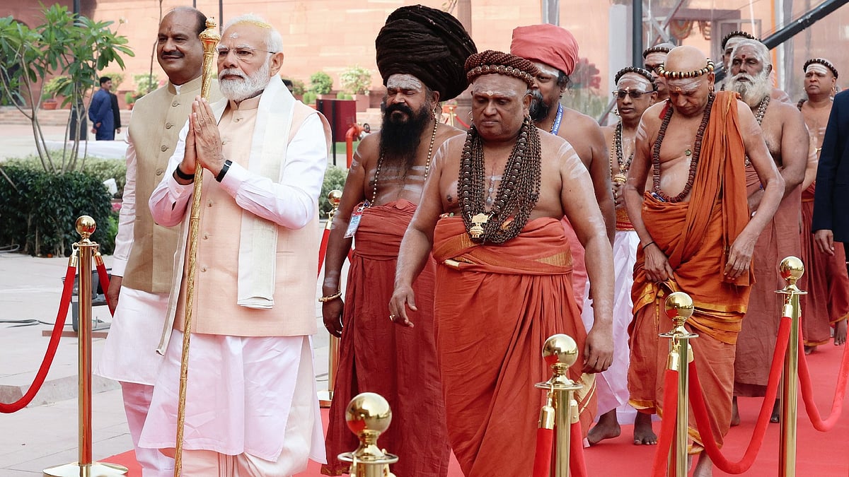 PM Modi holding the sengol with a posse of priests in tow (file photo)